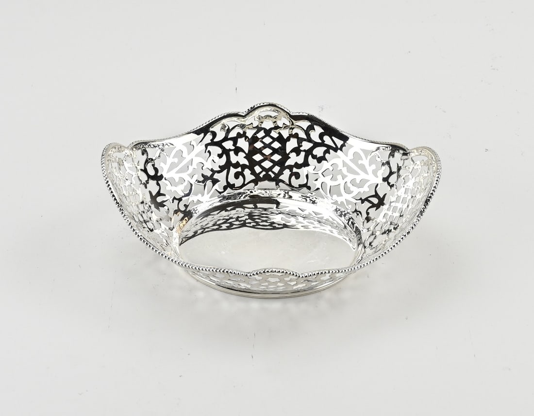 Silver candy basket: Silver bonbon basket, 835/000, oval contoured model with sawn Biedermeier pattern and a pearl edge. The basket is placed on an oval ring with fillet edges. approx. 146 grams. 18x12x6cm. In good