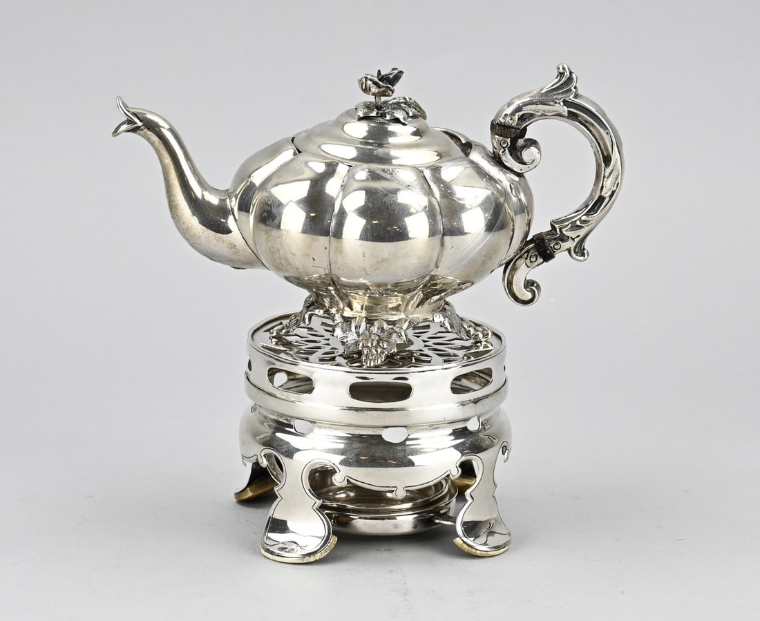 Silver teapot & stove: Silver teapot on stove, 833/000. Pumpkin-shaped teapot, placed on 4 legs with grapevines, provided with a curled handle with acanthus leaves and a flower bud on the lid. Placed on a cylindrical stove