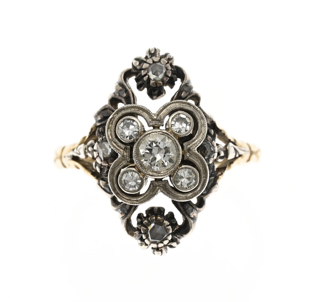 Gold ring with silver head and diamond: Yellow gold ring, 585/000, with silver and diamonds. Ring with a silver element set with 4 bolsewing cut diamonds. On top of this element is a white gold element with 5 brilliant cut diamonds,