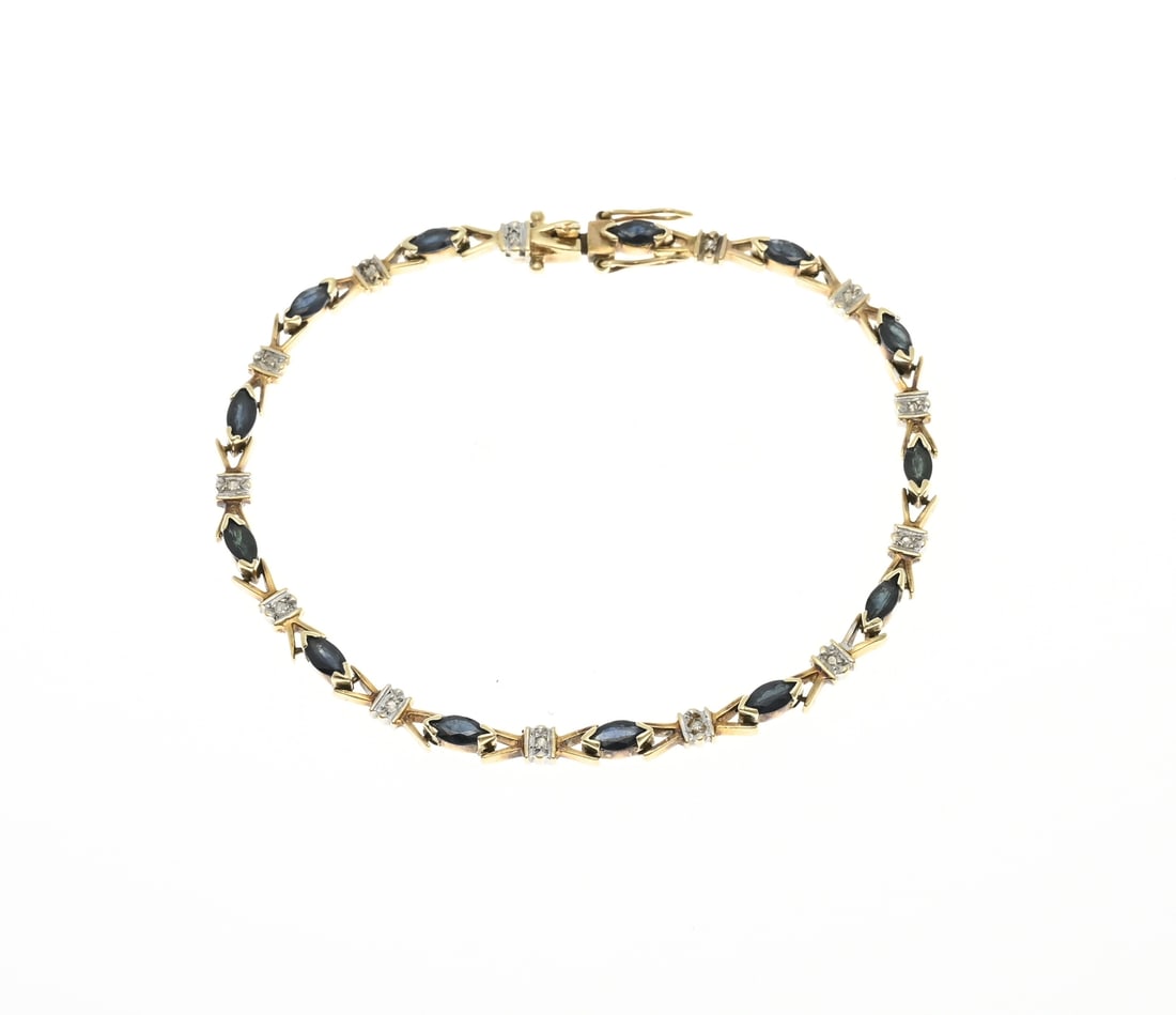 Gold bracelet with diamond and sapphire: Yellow gold bracelet, 585/000, with sapphire and diamond. Bracelet with 13 marquise faceted sapphires and in between a white gold setting with singlecut diamonds. Width 3.5 mm. Length 17.8 cm. With