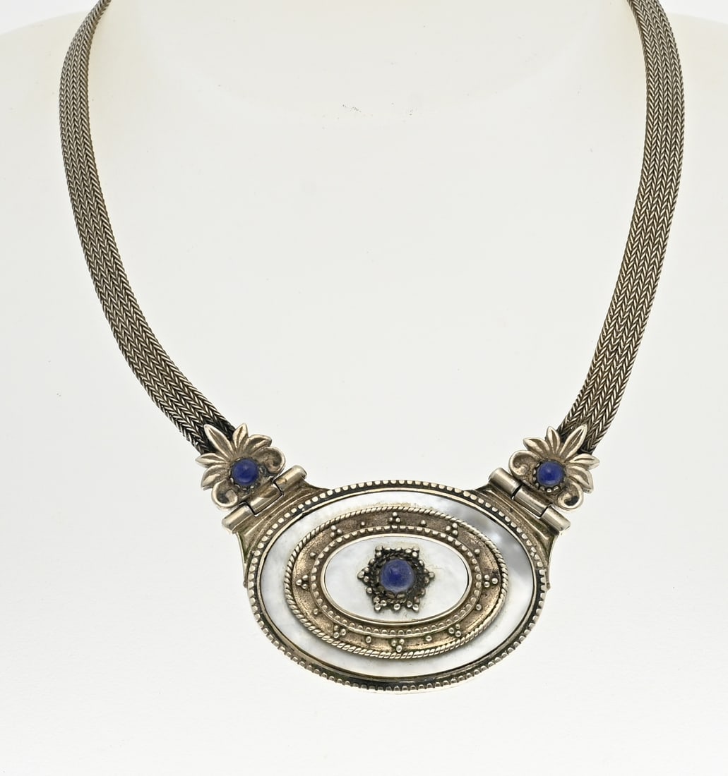 Silver choker with mother of pearl and lapis: Silver choker, 925/000, with mother of pearl and lapis lazuli stones. Choker made of a flat braided necklace with an oval silver element with mother of pearl and silver elements with lapis lazuli in t
