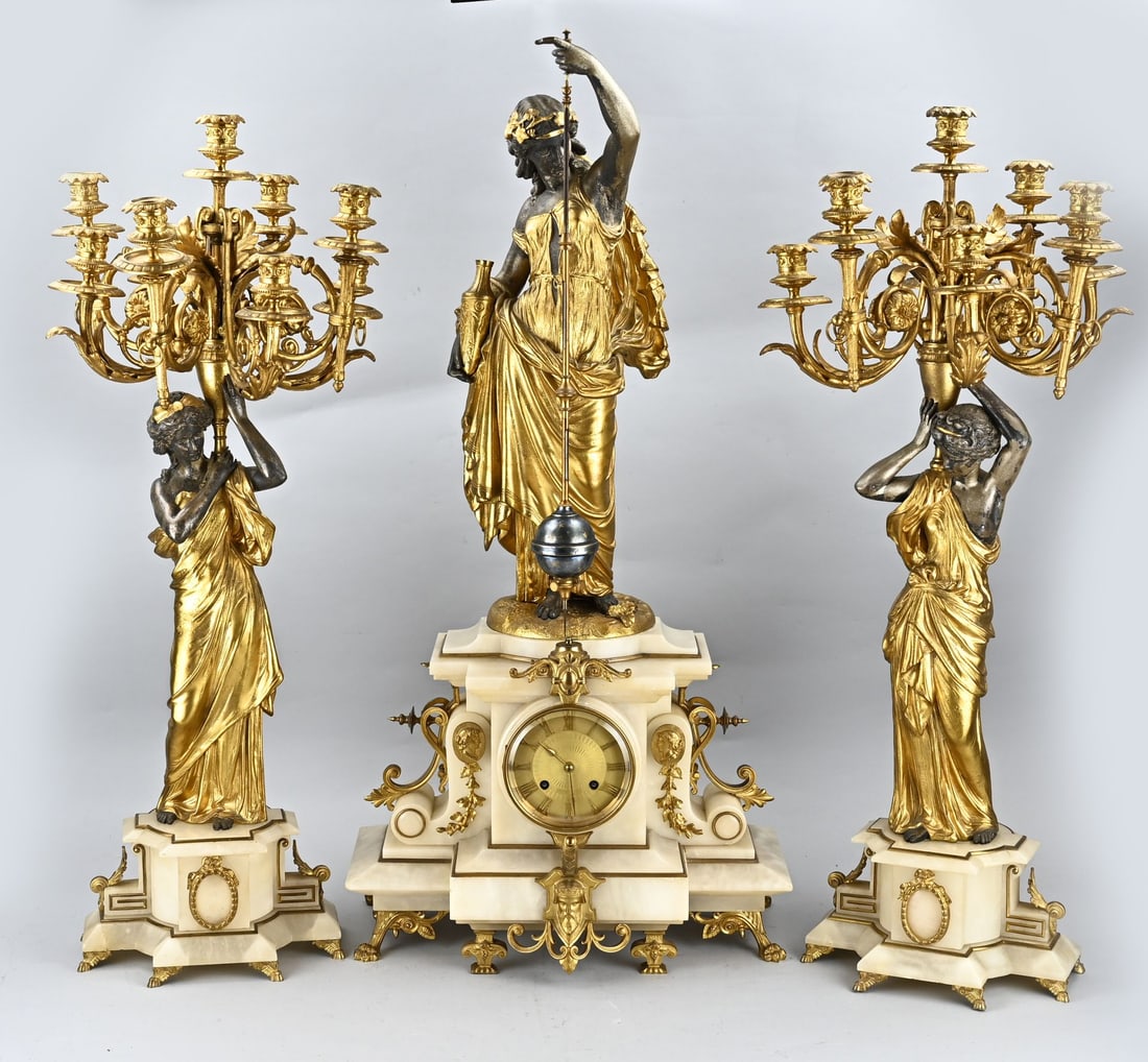 Rare 3-piece clock set, 1870: Capital mysterious French clock set of alabaster with gilded female figures. With systeme Farcot automaton. Circa 1870. Pendulum with ball turns circles. Eight-day movement, half-hour strike. Japy Fre