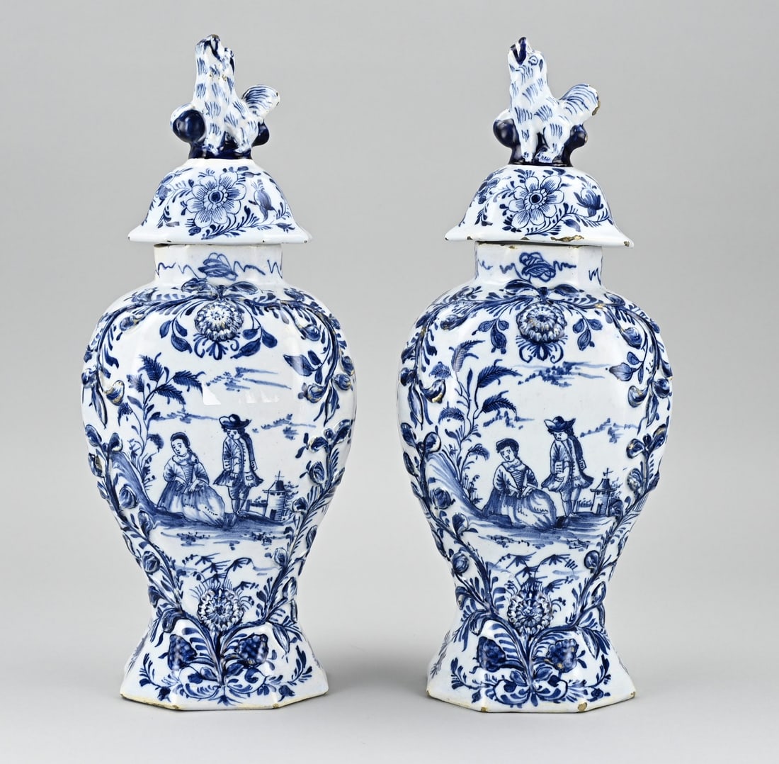 2x Delft lidded vase, H 35 cm.: Two 18th century Delft faience covered vases with romantic figures decoration + worked floral decorations. Dimensions: H 35 cm. In good condition.