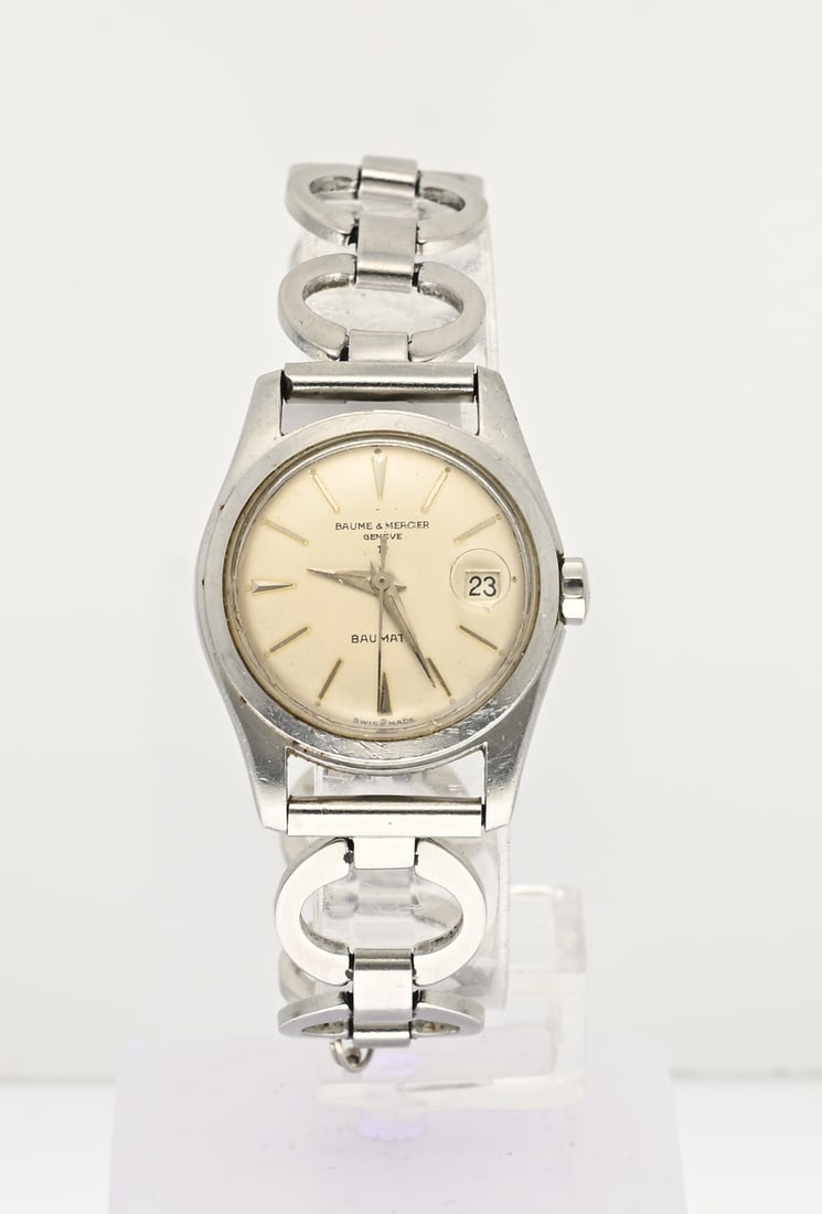 Vintage Baume Mercier watch: Vintage Baume & Mercier women's watch, Baumatic, with a round steel case and a date dial with a date window in the crystal. 1213. Attached to a steel link bracelet, not original. In good condition.