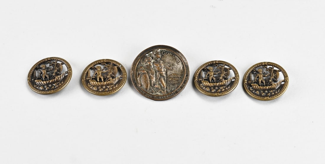 Antique buttons: Five antique German buttons, including a Gut Heil pin from 1900. Four openwork brass buttons (maritime), featuring a boy on a sailboat. Size: 3.5-4.8 cm. In good condition.