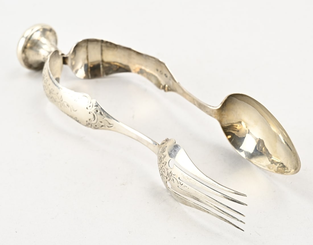 Silver salad tongs: Silver salad tongs, 833/000, contoured model decorated with floral engraving. MT.: unclear, dated: 1864. approx. 101 grams. 26 cm. Slightly out of shape and fitted with a repair.