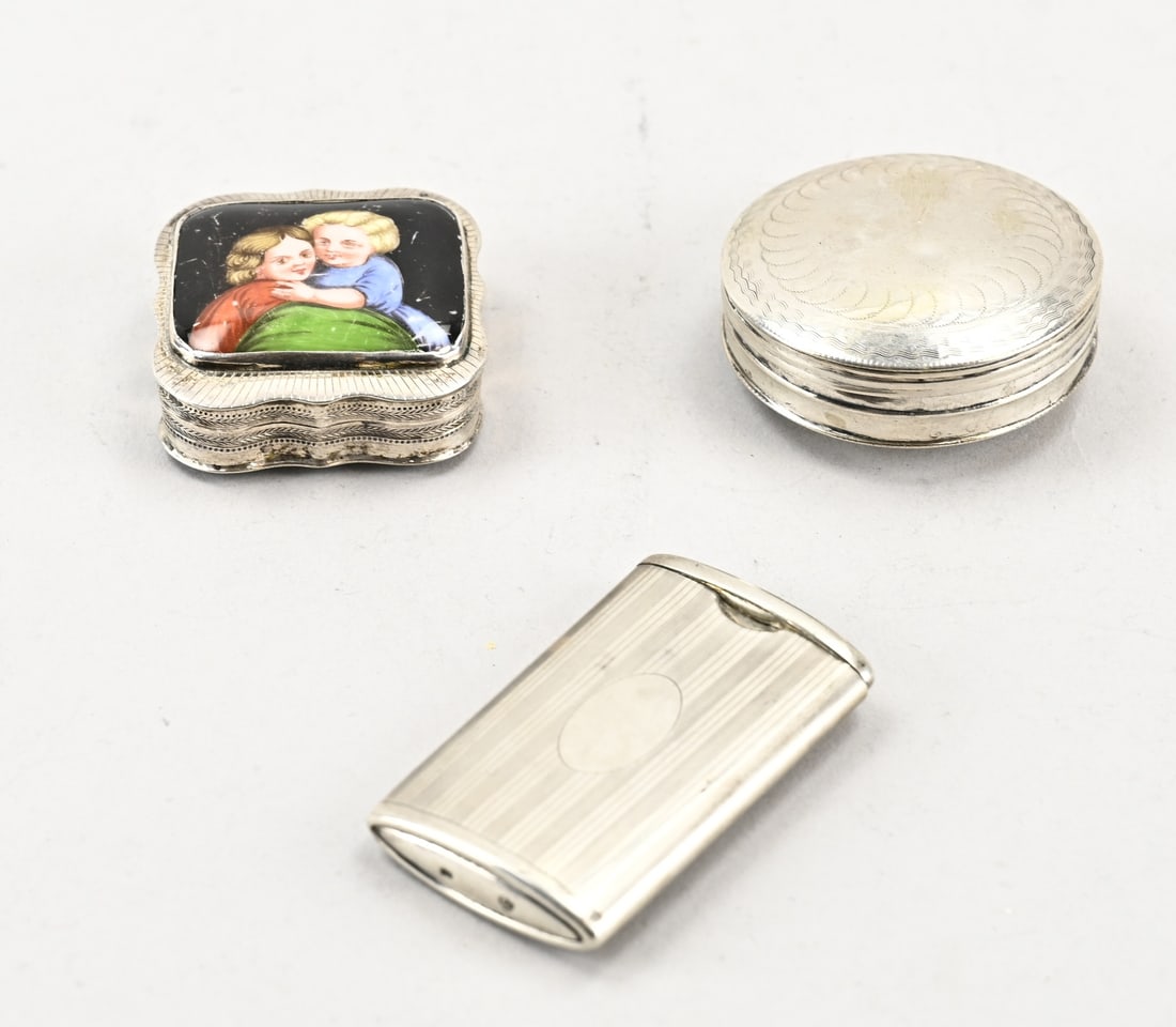 3 Silver boxes: Lot of 3 silver boxes, 833/000, a round box with engraving, a square contoured box with a soldered porcelain element with painting, Schoonhoven, jl Q: 1850, and a rectangular sliding vesta with line d