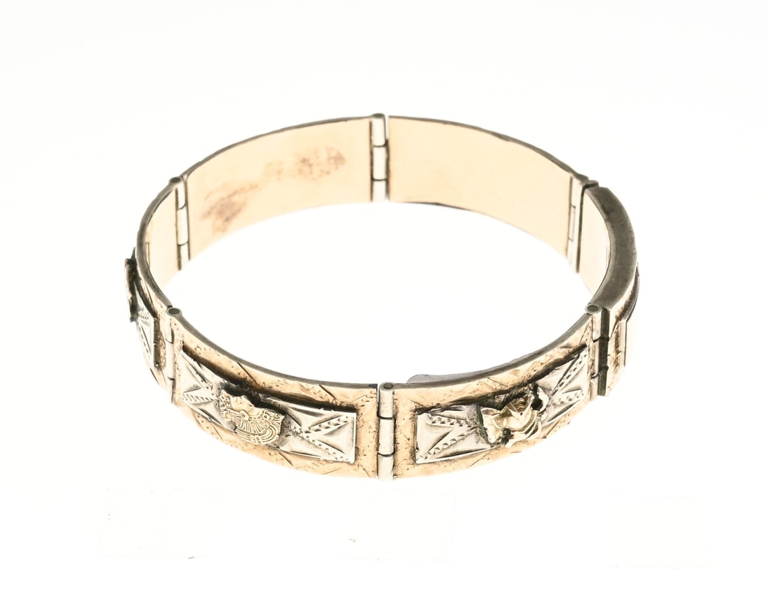 Silver and gold bracelet: Silver and gold bracelet with rectangular elements decorated with engraved ornamentation and featuring soldered gold elements including a clover, knight, and eagle. The bracelet is fitted with a box c