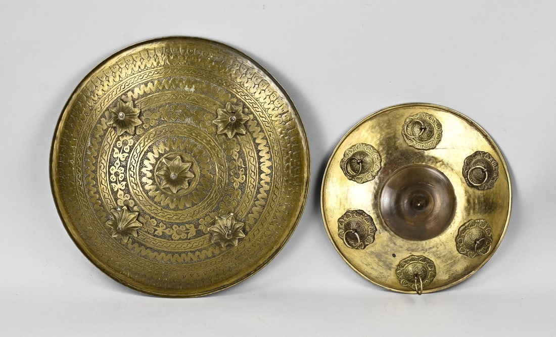 2x Oriental shields Ø 22 - 33 cm.: Two brass Indo-Persian shields, with mountings. 19th - 20th century. Dimensions: 22 - 33 cm. In good condition.