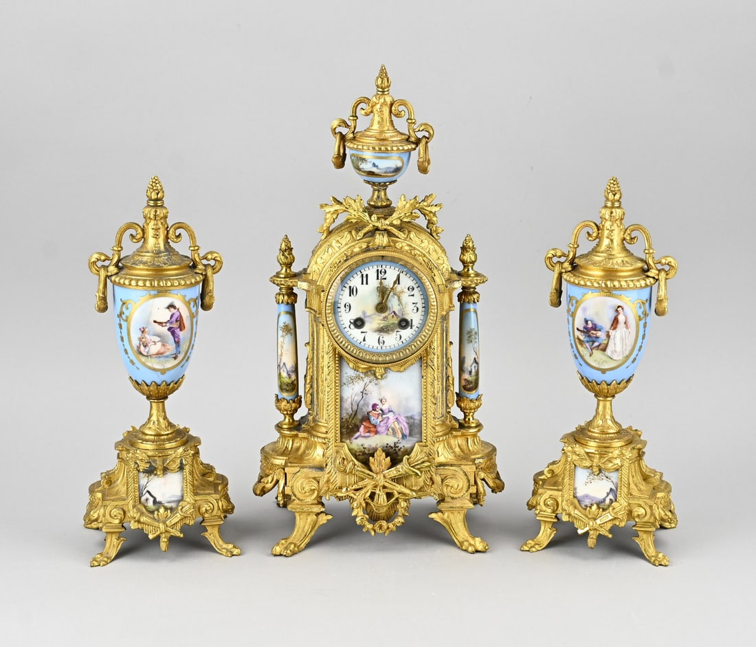 3-piece Sevres mantel clock set, 1890: Antique three-piece gilt Sevres porcelain clock set. France. Circa 1890. Eight-day movement, half-hour strike. Japy Frères. One vase with a hairline crack. Dimensions: H 34 - 42 cm. In fair/good