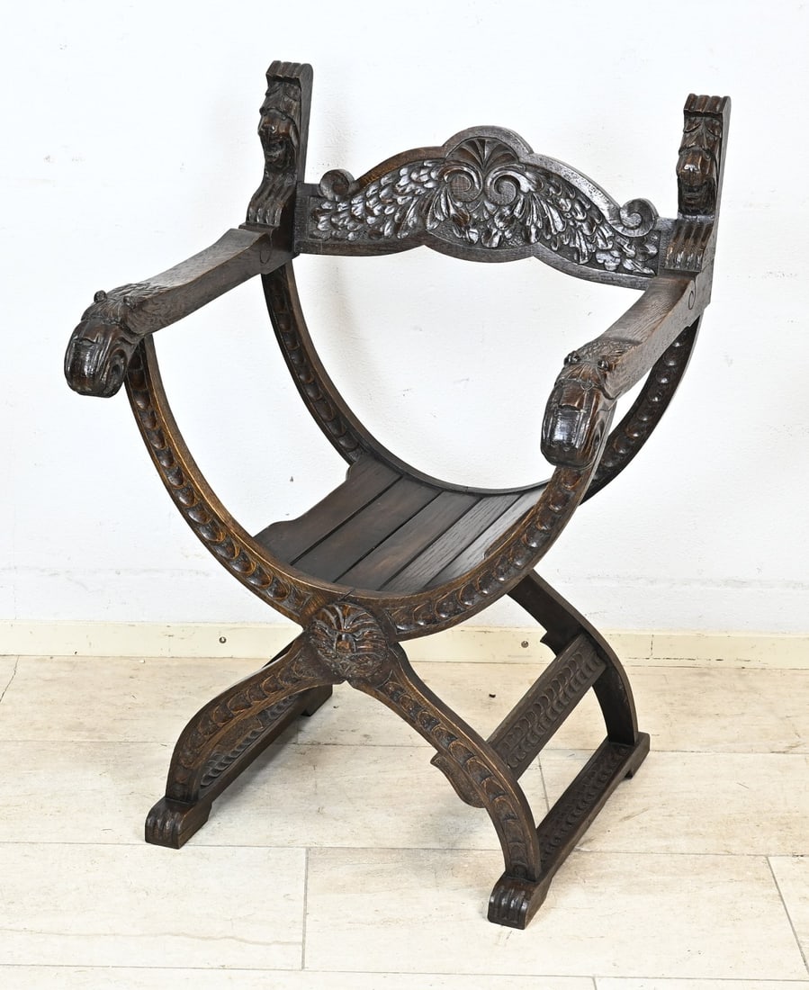 Historic scissor chair: Antique historic oak scissor chair with lion's heads. Dimensions: 95 x 62 x 64 cm. In good condition.