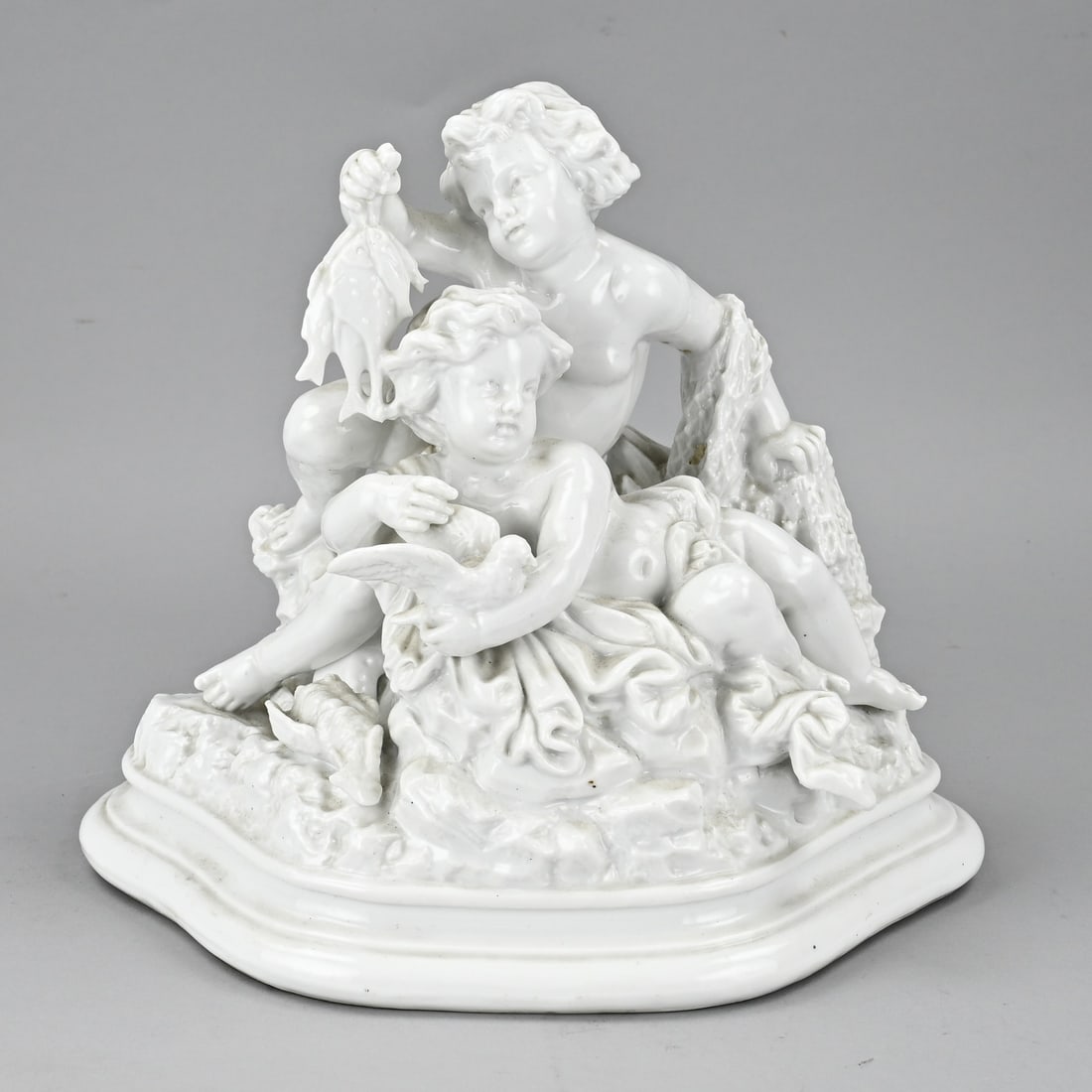 Porcelain group: 19th Century German Volkstedt Rudolstadt E. Bohne & Söhne white porcelain figure group with putti. Dimensions: 25 x 26 x 15 cm. In good condition.