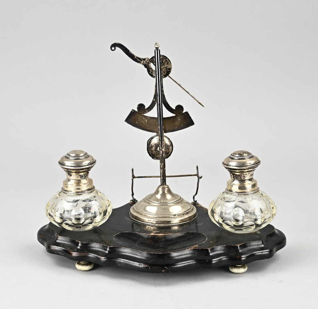 Silver ink set: Fine inkwell set on a contoured wooden base with 2 cut crystal inkwells with silver collars and caps, and a silver pen holder and scales decorated with a beaded rim. MT.: K.Schuurman, Amsterdam,