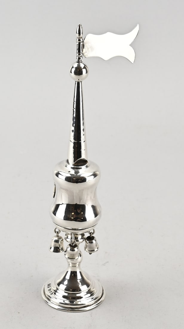 Silver spice mill/ besamim: Silver besaim tower, 925/000, on a round base with bells and a pennant. MT.: AT&Sn, London, 1957. In good condition. 6x8x25cm. Approx. 134 grams.
