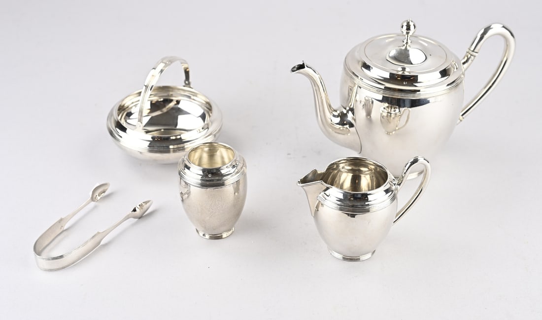 Silver tea set, 4-piece: Silver tea set, 833/000, with a teapot, milk jug, sugar bowl with handle and tongs, and a spoon vase, all decorated with filigree borders on the top and bottom. Maker: Koninklijke Zilverfabriek Begeer