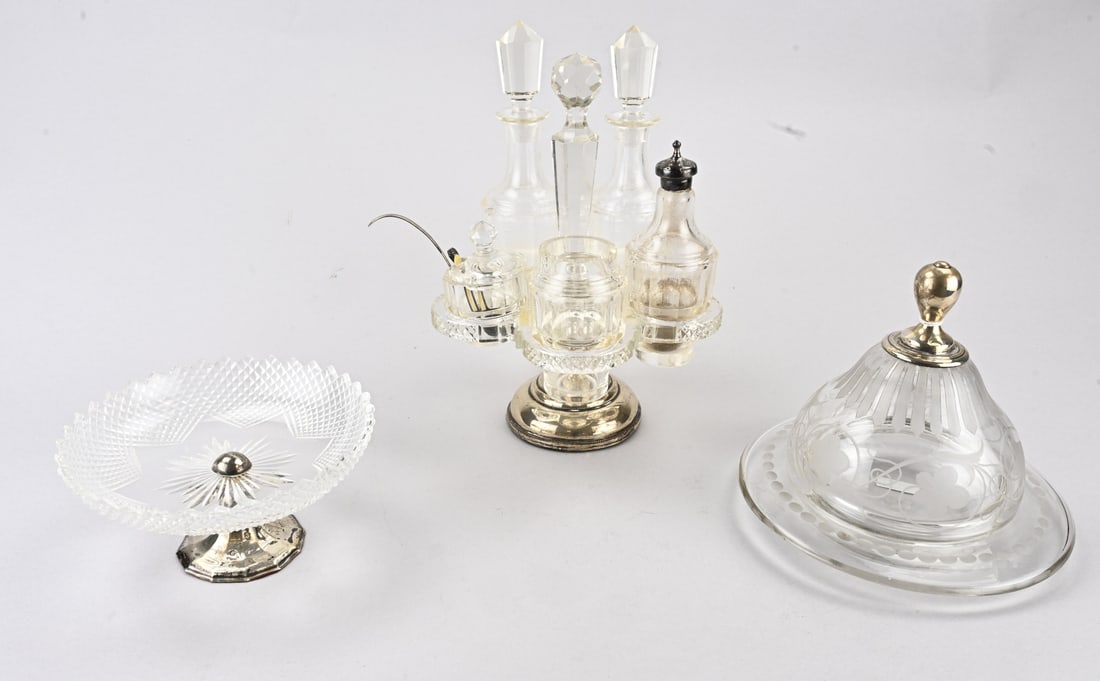 3 parts crystal with silver: Three pieces of crystal with silver, a butter dish decorated with etched floral motif, with a silver knob, slightly dented. 833/000. A tazza with Russian cut glass, placed on a round silver base,
