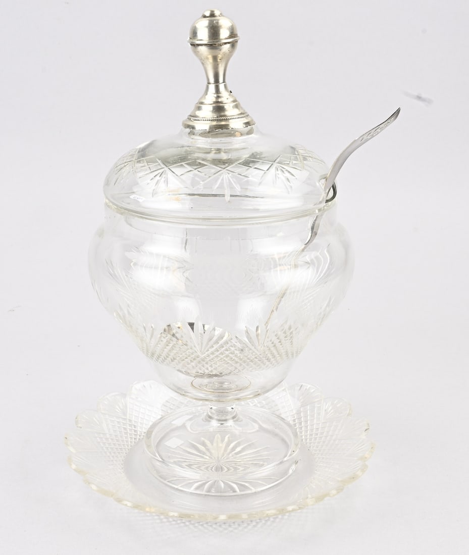 Bowlpot with silver morello cherry spoon: Crystal bowl on a saucer, fitted with a silver knob on the lid, 833/000. And a silver morello cherry spoon. ø20x30cm. Knob slightly crooked and damaged along the rim. A few chips, otherwise in