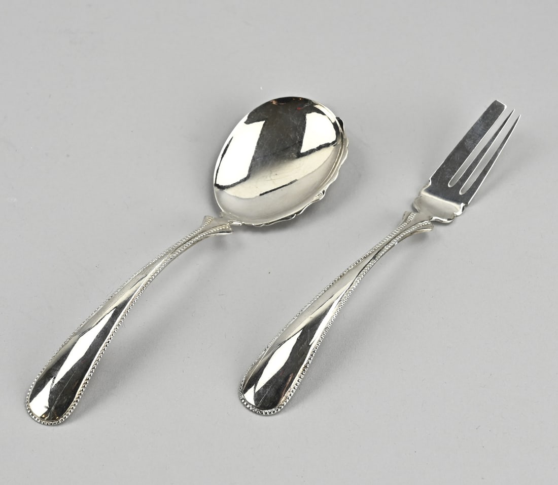 Silver ginger cutlery set: Silver ginger cutlery set, 833/000, spoon and fork decorated with a pearl rim. Maker: A. & JJ Driesen, Schoonhoven. 1896. Approx. 61 grams. In good condition.