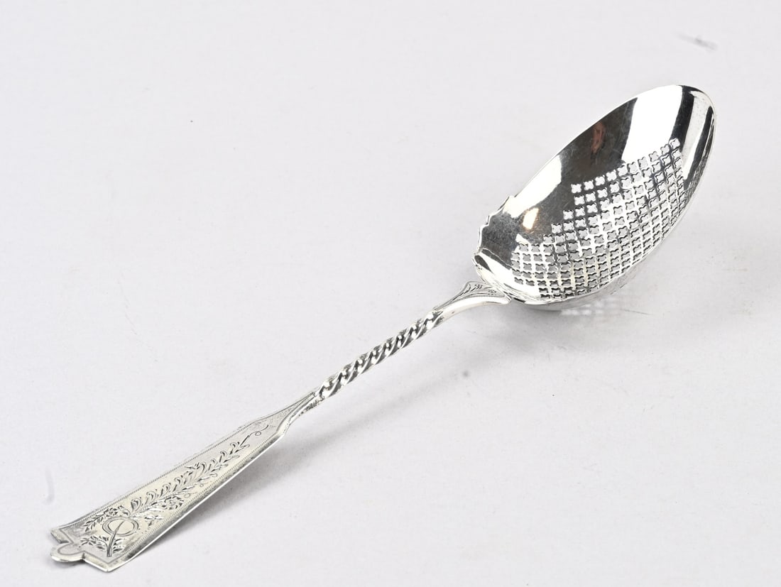 Silver wet fruit scoop: Silver fruit spoon, 833/000, with an openwork pear-shaped bowl featuring a contoured rim, attached to a partially twisted handle with floral engraving. MT.: J. van Os- van den Abeelen, Schoonhoven,