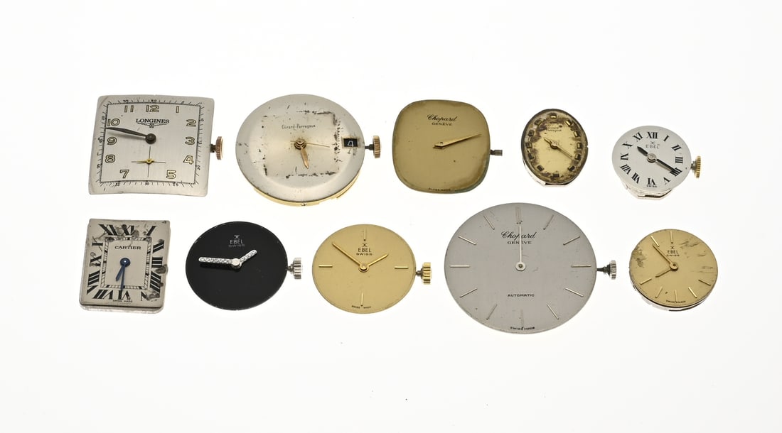 Lot of timepieces and dials, including Ebel.: Lot of loose movements, dials including Ebel, Longines, Chopard, Girard-Perregaux. Functionality not tested. Some damaged.
