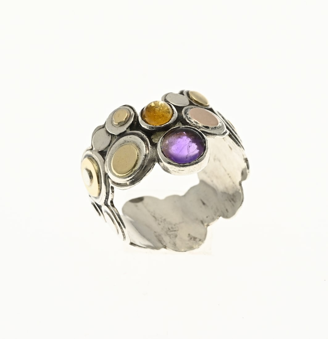Silver ring amethyst and citrine, Poelie Jansen: Handmade silver ring, 925/000, inspired by Oriental goldsmithing, crafted from round elements decorated with soldered yellow gold elements, 585/000, and set with a cabochon-cut amethyst and citrine
