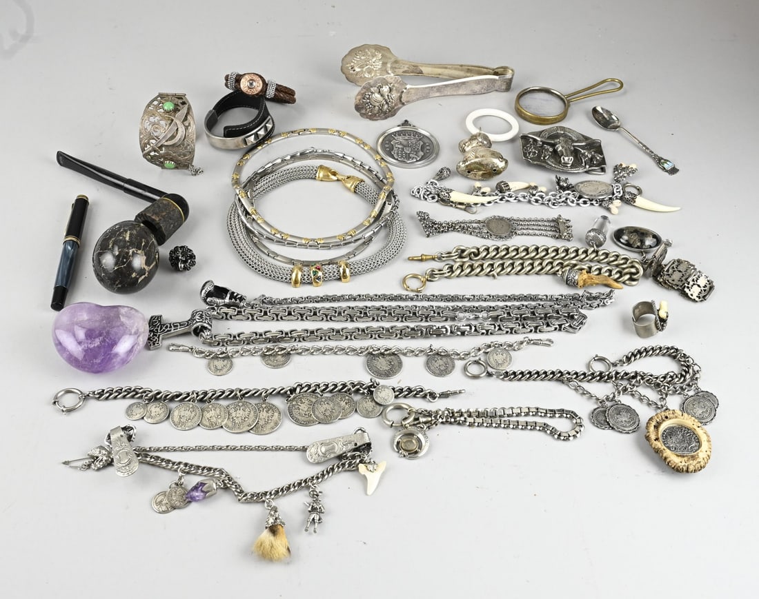 Lot of various jewelry: Lot of various jewelry including an amethyst heart, gemstone egg, steel chokers, various chatelaines, necklaces, and a rattle.