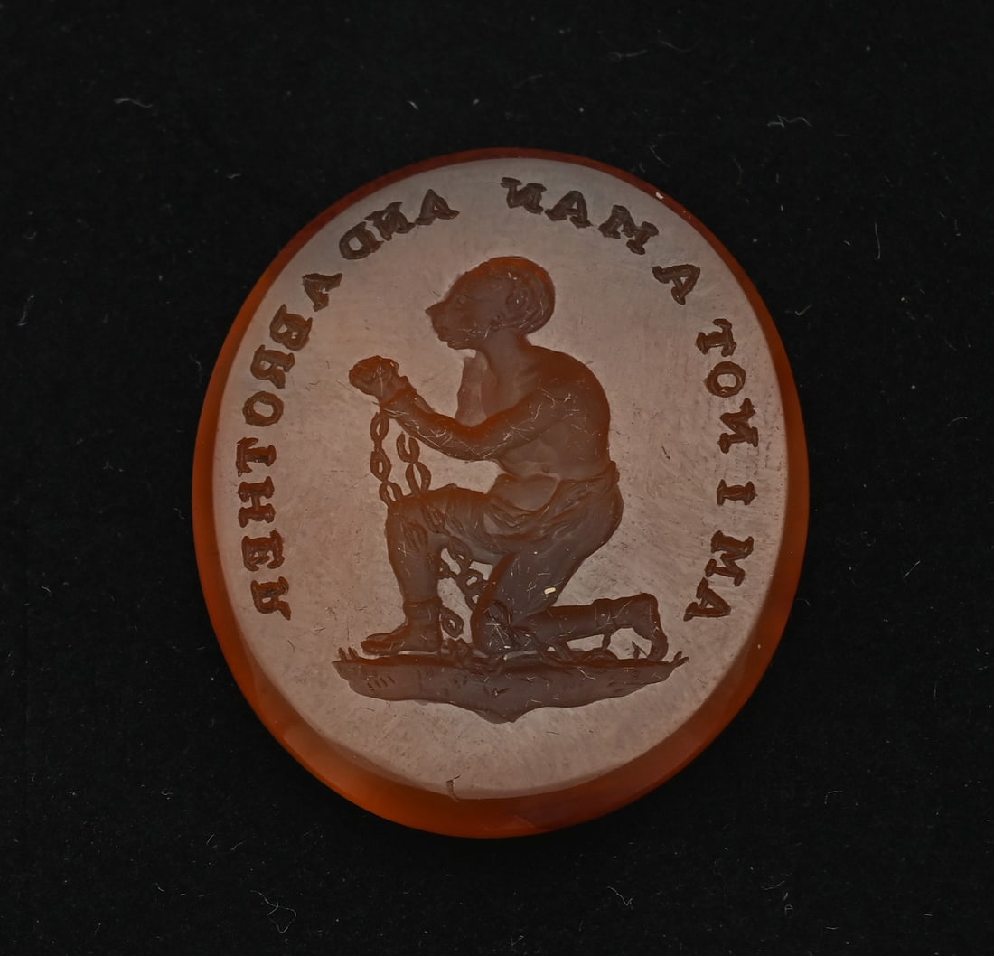Carnelian intaglio wax seal stamp slavery USA: Carnelian intaglio wax seal stamp slavery USA, First half of the 19th century, North America. After a design by Joshua Wedgwood. "AM I NOT A MAN AND A BROTHER". 24x29mm. In good condition.