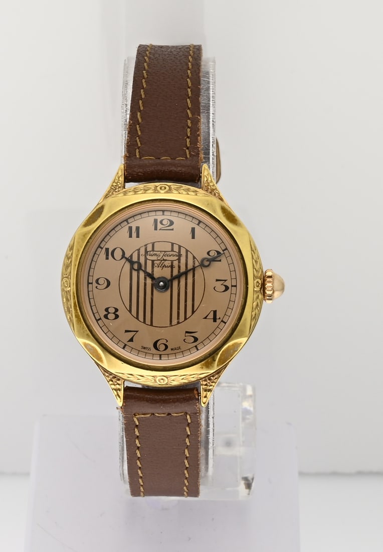 Vintage Alpina watch: Vintage Alpina, Numa Jeannin by Alpina, Lady, with gold-plated case featuring detailing. Mechanical. Case diameter 27 mm. Case number: ND50 - 1709. Mounted on a brown leather strap. Working and in