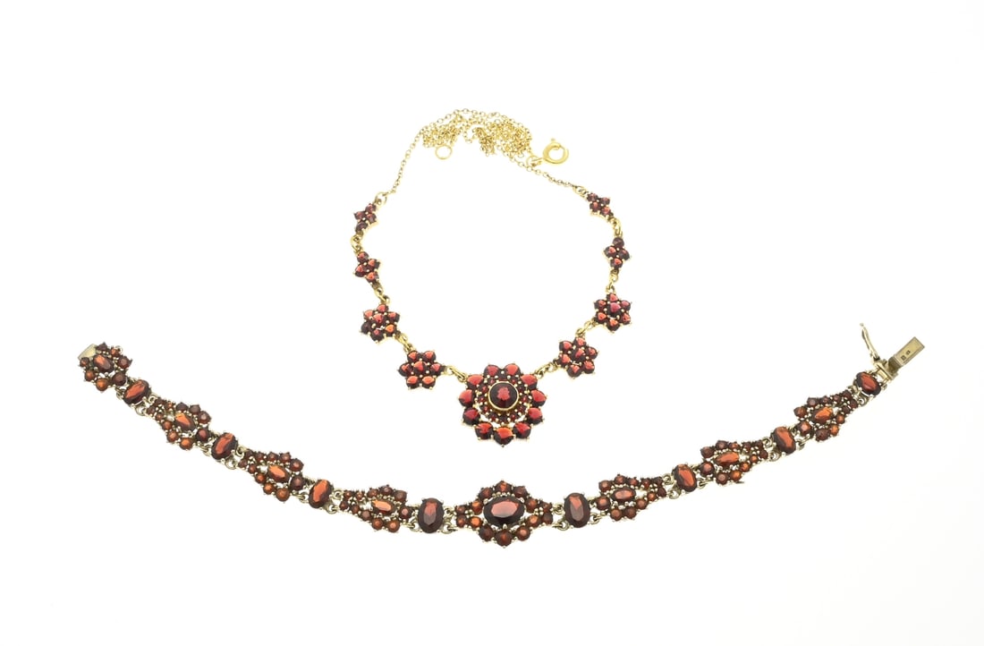 Choker and bracelet with garnet: Double choker and a silver-plated bracelet with garnets. Necklace with 5 rosettes in the center set with garnets, rosette diameter 8.5-19 mm. And a bracelet with an oval rosette and pear-shaped elemen