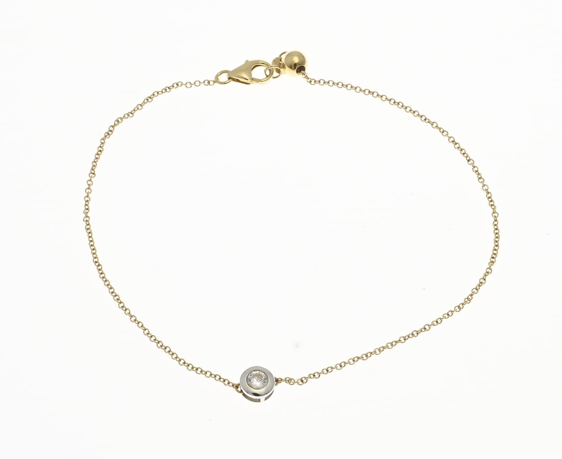 Gold bracelet with stone: Yellow gold bracelet, 585/000, with a plain white gold setting, ø 4.8 mm, set with a zirconia stone. The bracelet has a round anchor link and is fitted with small balls for adjusting the length.