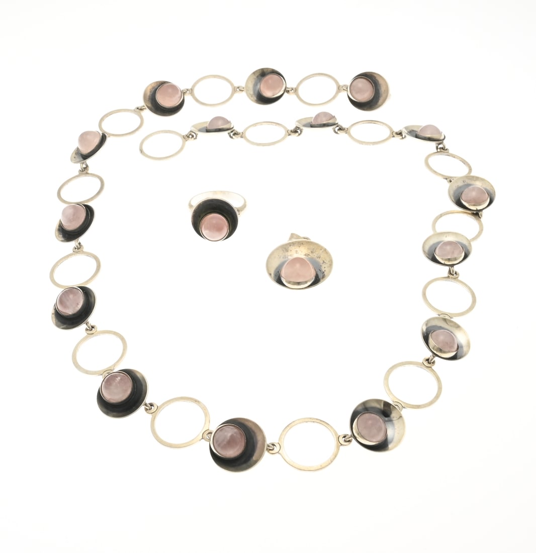 3 Silver rose quartz jewelry, Danish: Three pieces of silver jewelry, 925/000, with rose quartz. A ring, pendant, and necklace with a round element set with a round rose quartz. Marked: NE From, Denmark. Ring head diameter 15.5 mm.
