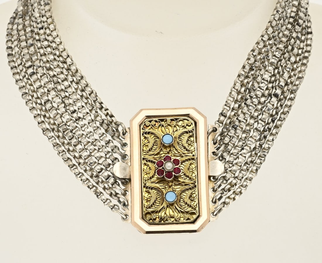 Silver necklace with turquoise: Silver choker with 8 rows of jasseron chain attached to a rectangular contoured rose gold-plated clasp decorated with filigree, turquoise, and red stones. Length 33 cm. Approx. 67 grams. In good