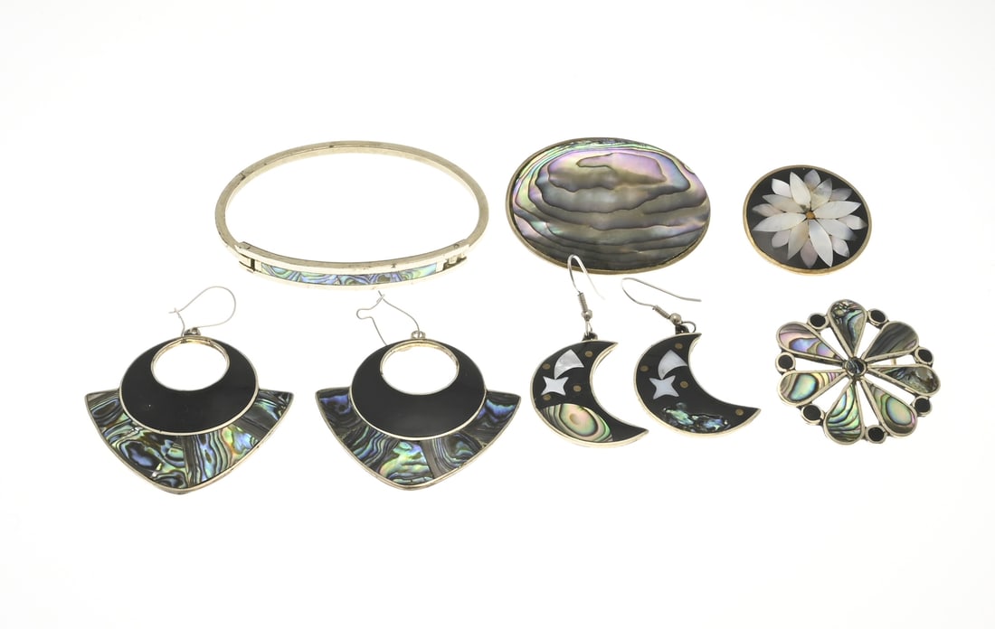 Lot of Alpaca jewelry: Lot of alpaca jewelry with mother-of-pearl and enamel. 2 pairs of earrings, 3 brooches, and a bracelet. One earring is missing a small piece of mother-of-pearl, otherwise in good condition.