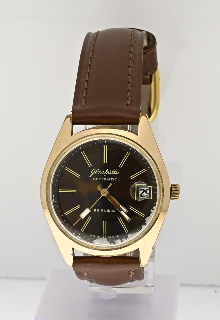 Glashutte watch: Gold-plated vintage Glashutte Spezimatic watch with a brown dial featuring a date display. ø 35 mm. Case number: 839017. With brown leather strap. Working. Dial slightly tarnished, otherwise in