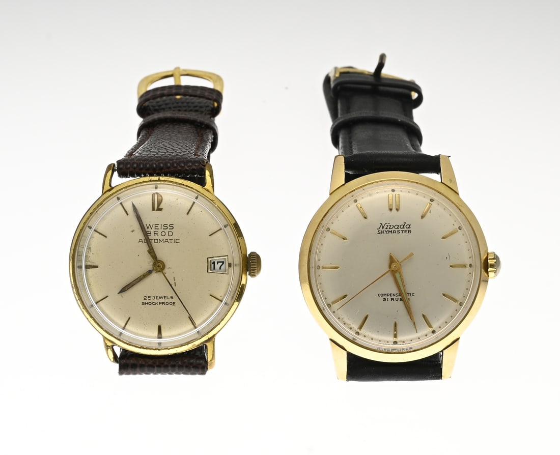 2 Vintage Gold-Plated Watches: Two vintage gold-plated mechanical watches. One WEISS BROD automatic watch with date display, case diameter 33 mm. And one Nivada Skymaster compensamatic watch, case diameter 33 mm. Both with leather