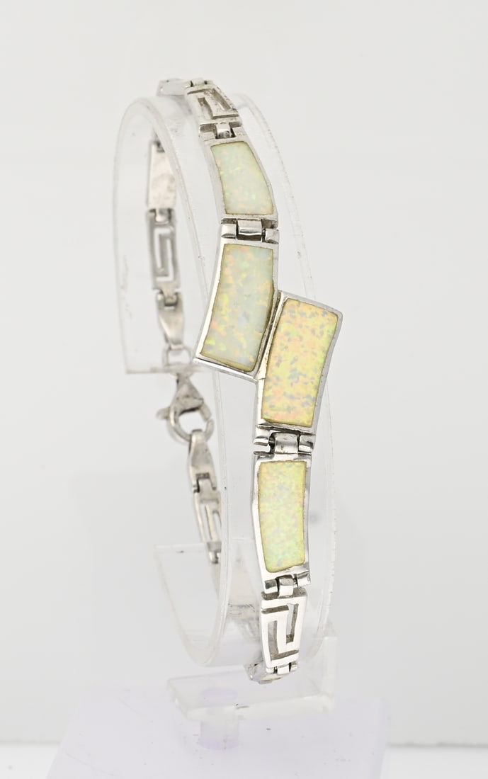 Silver bracelet with opal: Beautiful silver bracelet, 925/000, with white opal. Bracelet with meander links and clasp, partly set with rectangular links with white opal. Width 3.5-18 mm. Fitted with a lobster clasp. Rhodium