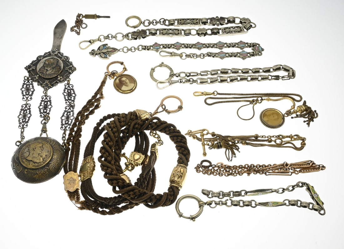 Lot of watch chains: Lot of various metal and hair watch chains, featuring medallion pendants and a watch case with a clip. In good condition.