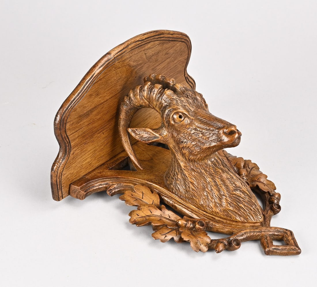Black Forest wall console: Antique walnut Black Forest wall console with ibex head. Circa 1900. Dimensions: 24 x 23 x 15 cm. Part of the antler is missing. In reasonable condition.