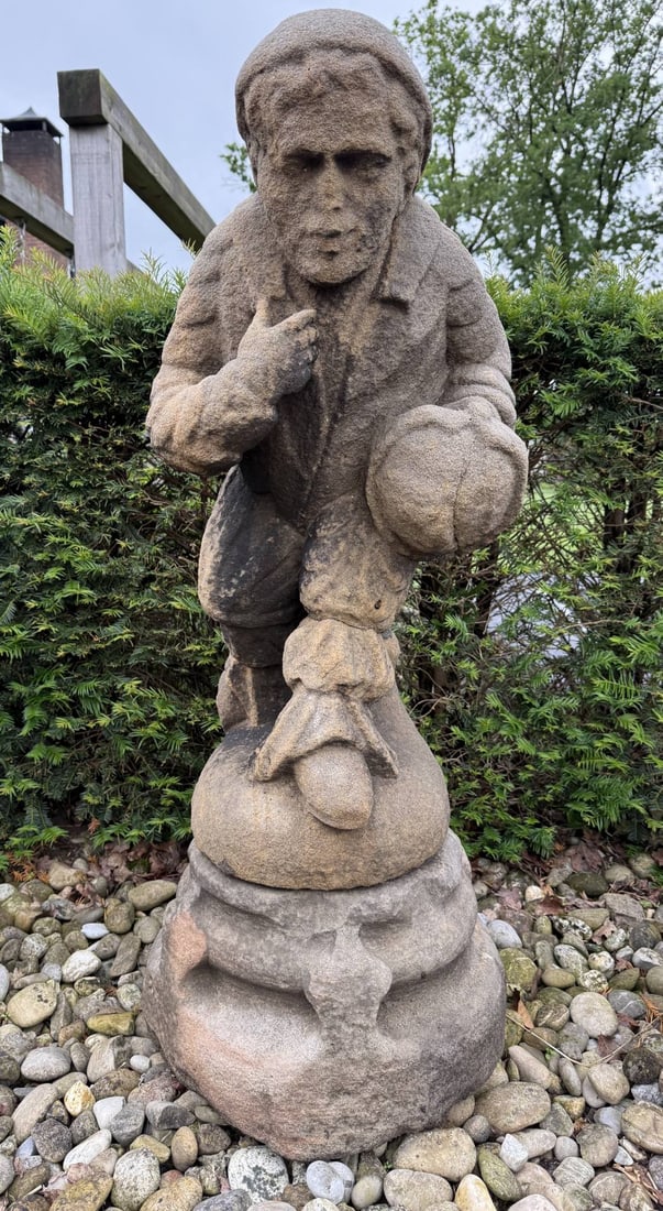 Sandstone statue on pedestal, H 121 cm.: Rare large, 16th-17th century sandstone figure on a console. Man in traditional costume, head covering, and helmet in his hand. Dimensions: H 121 cm. In good condition.