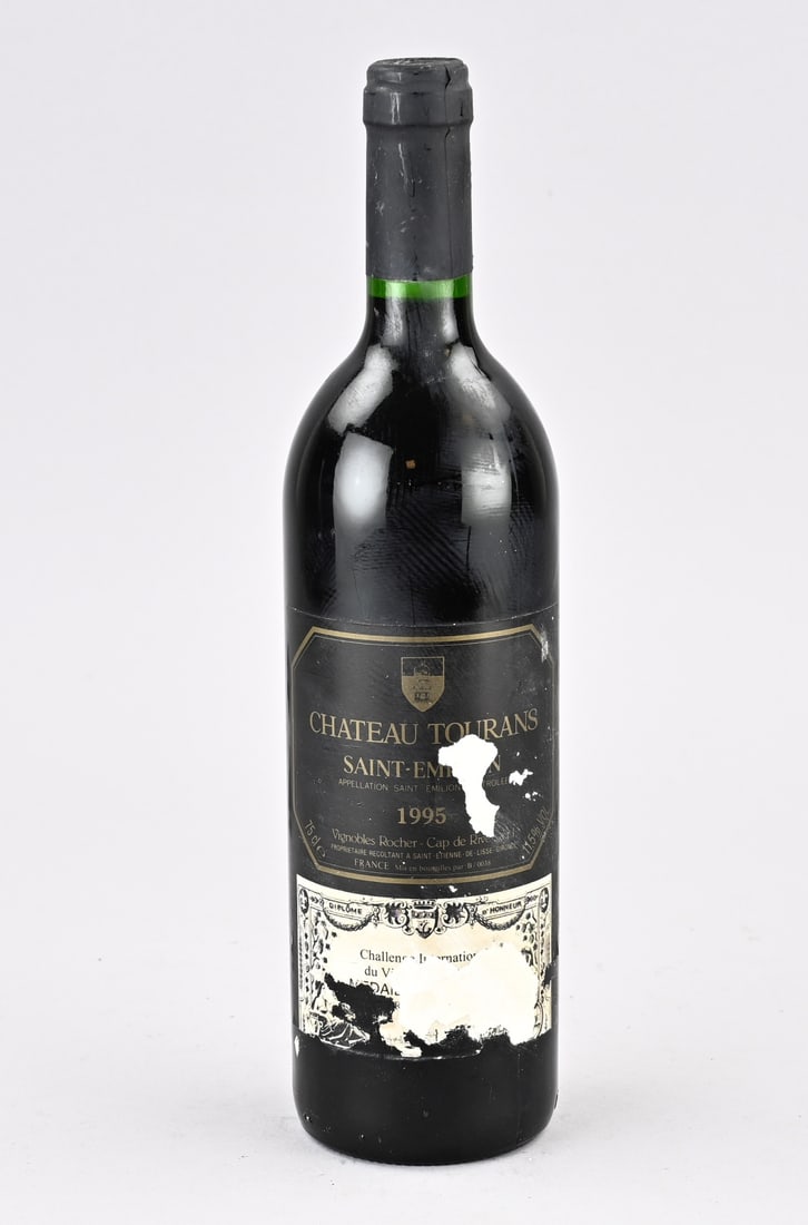 Bottle of wine, Chateau Tourans Saint Emilion 1995: Bottle of French red wine. Chateau Tourans Saint Emillion 1995. Vignobles Rocher Cap de Rive Medal D. Silver. Dimensions: H 30.5 cm. In good condition.