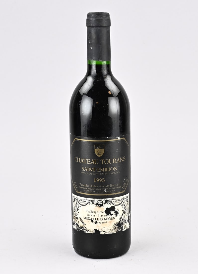 Bottle of wine, Chateau Tourans Saint Emillion 1995: Bottle of French red wine. Chateau Tourans Saint Emillion 1995. Vignobles Rocher Cap de Rive Medal D. Silver. Dimensions: H 30.5 cm. In good condition.