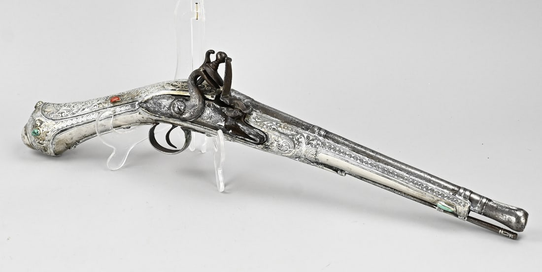 Silver pistol, L 49 cm.: 18th-century flintlock pistol, with silver-plated coating, floral engraving, and gemstones. Probably for the Oriental market, Miquelet? Low silver alloy, with coral/turquoise stones. Dimensions: L 49