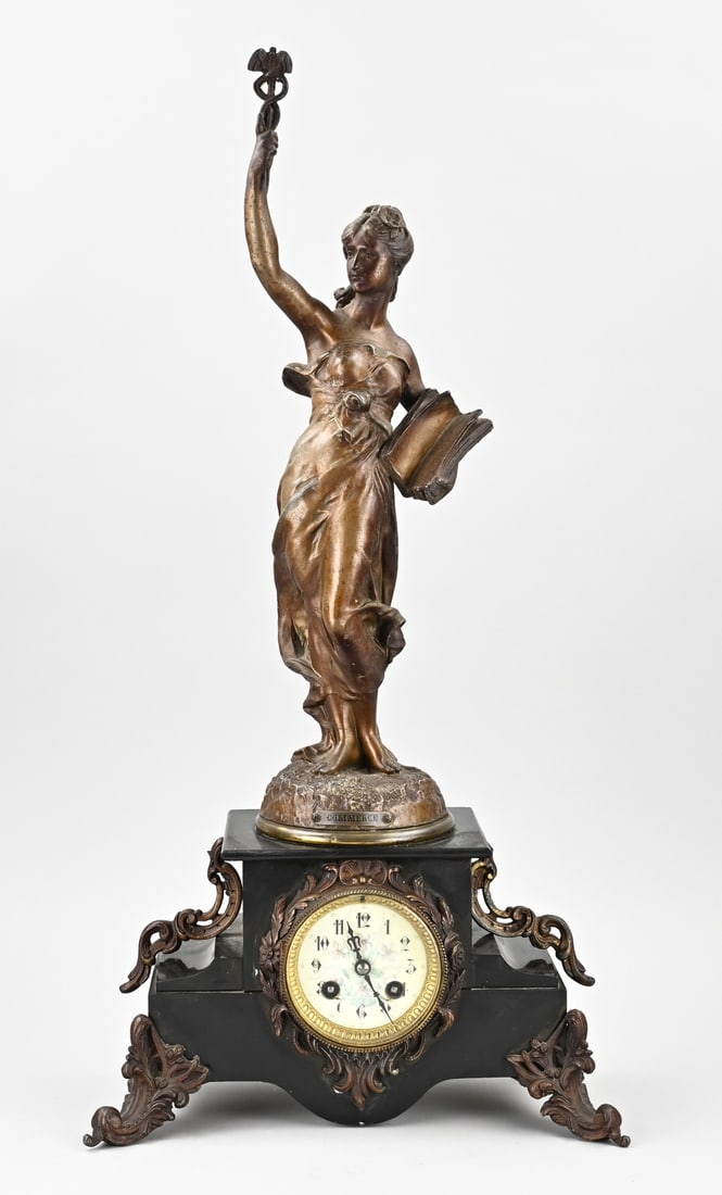 French pendulum clock, H 64 cm.: Antique French black marble clock, with a woman holding a scepter. Title: Commerce. Circa 1900. Art Nouveau. Eight-day movement, half-hour strike, spring pendulum. Dimensions: H 64 cm. In good