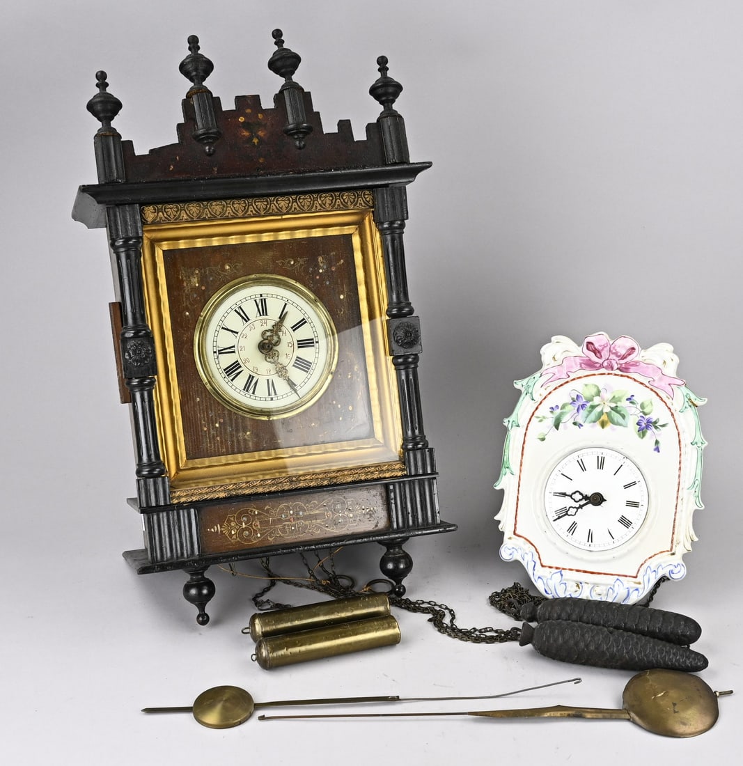 2x Black Forest clock: Two antique German Black Forest wall clocks. 19th century. 1x Large porcelain clock. 1x Bismarck clock. Dimensions: 26 x 55 cm. In good condition.