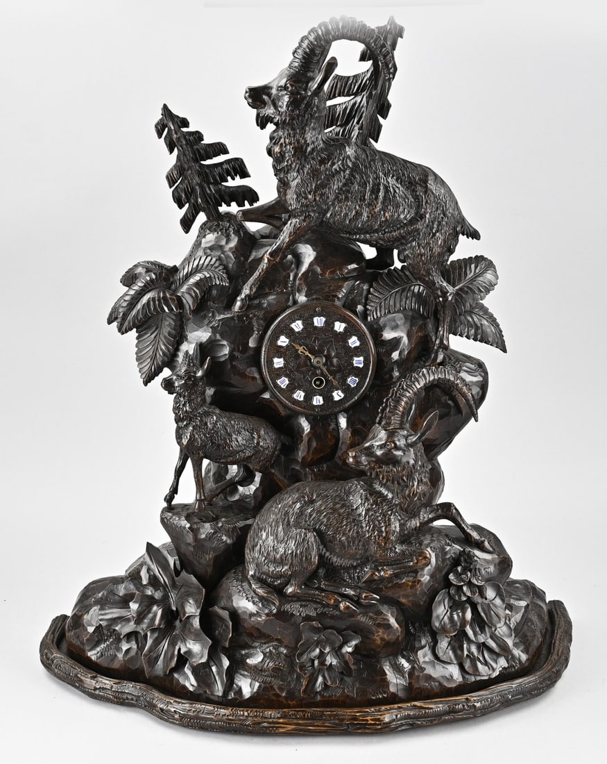 Black Forest clock with carving: Large German Black Forest carved clock with ibexes. Circa 1880. Dimensions: 67 cm. In very good condition.