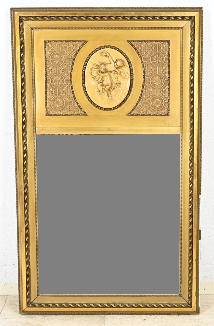 Mirror, 130 x 76 cm.: Antique mirror in Empire style, with relief putti. Circa 1900. Dimensions: 130 x 76 cm. In good condition.