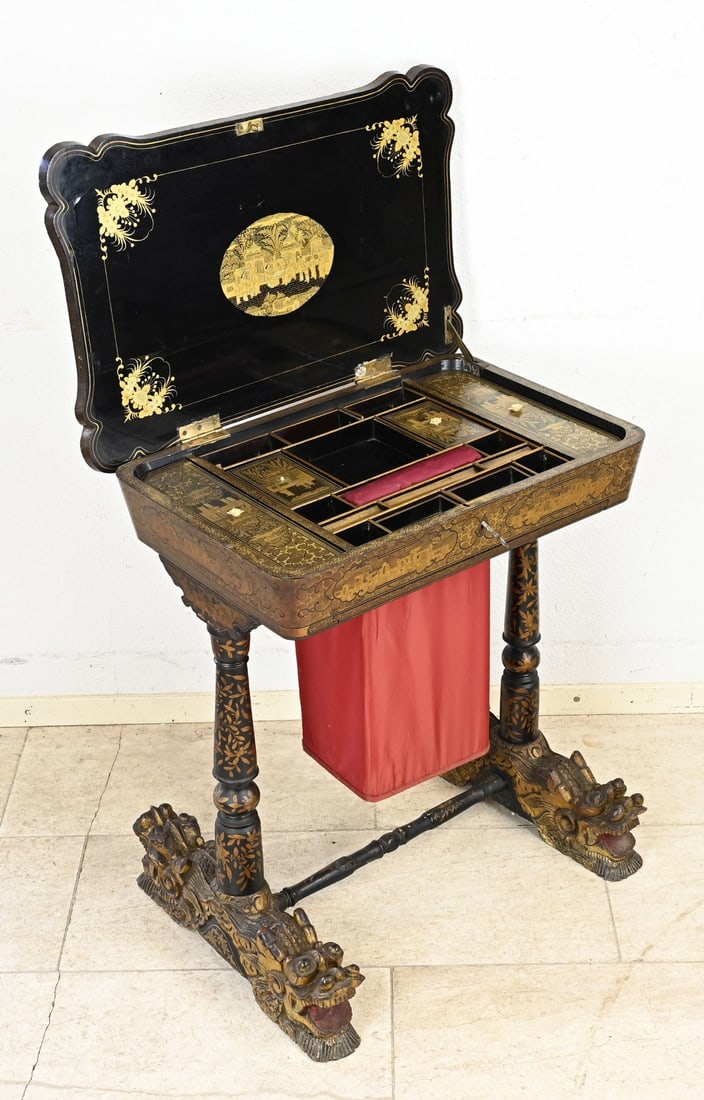 Chinese sewing table with lacquer finish: Beautiful 19th-century Chinese lacquer sewing table with detailed gold decoration. Also features gold decoration on the inside, plus compartments with lids, with Kylin heads, on legs. Dimensions: 74