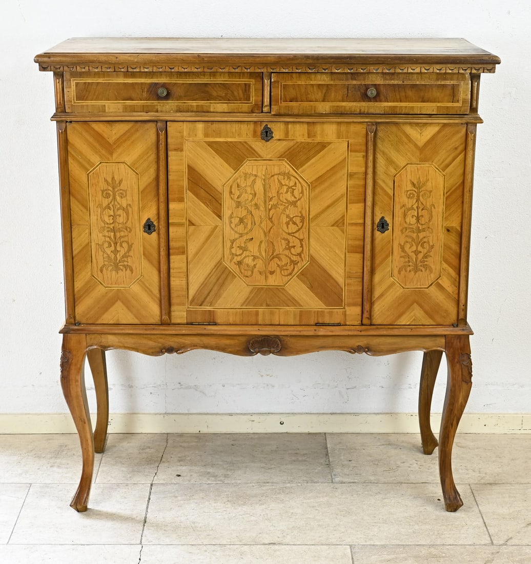 Nut cabinet, 1900: Antique walnut cabinet with floral inlay, bronze fittings, and standing on Queen Anne claw feet. Dimensions: 112 x 100 x 41 cm. In good condition.