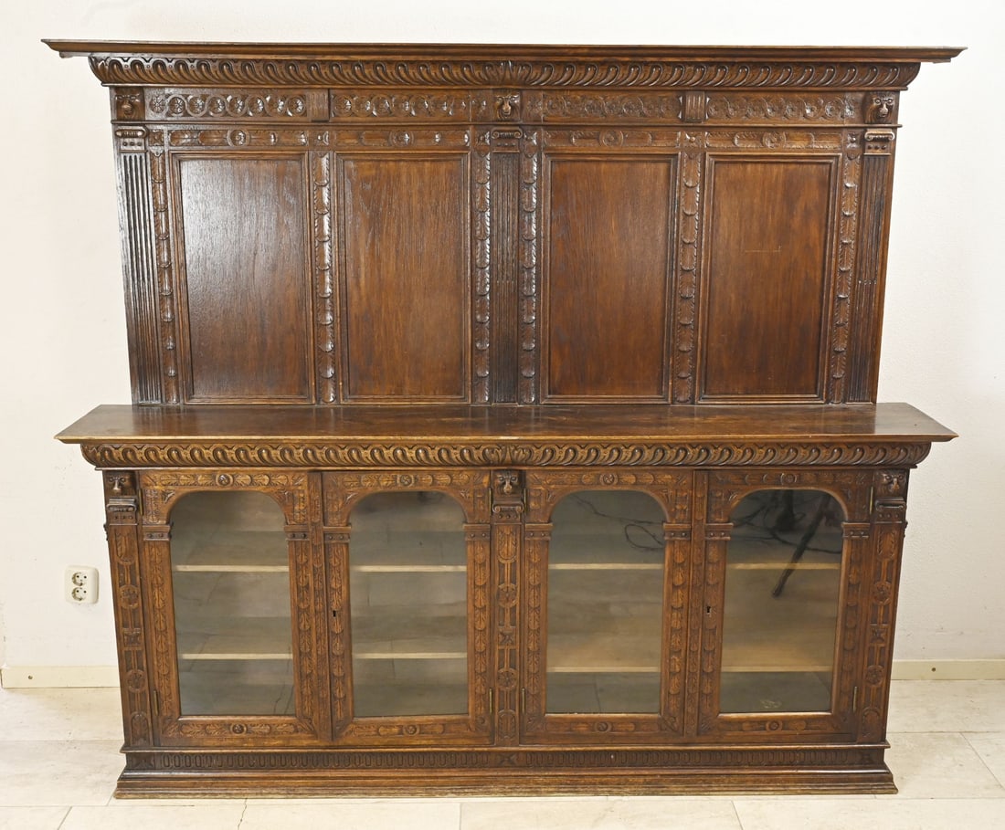 Oak display cabinet, 1880: Dutch oak Neo-Renaissance paneled display cabinet with four glass doors and shelves. Circa 1880. Dimensions: 163 x 35 x 185 cm. In good condition.