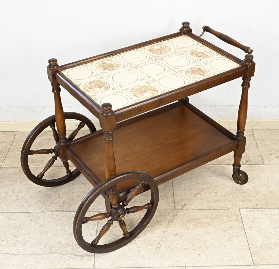 Tea trolley with tiles: Dutch mahogany tea trolley with tile panel on the top. Mid-20th century. Dimensions: 64 x 77 x 43 cm. In good condition.